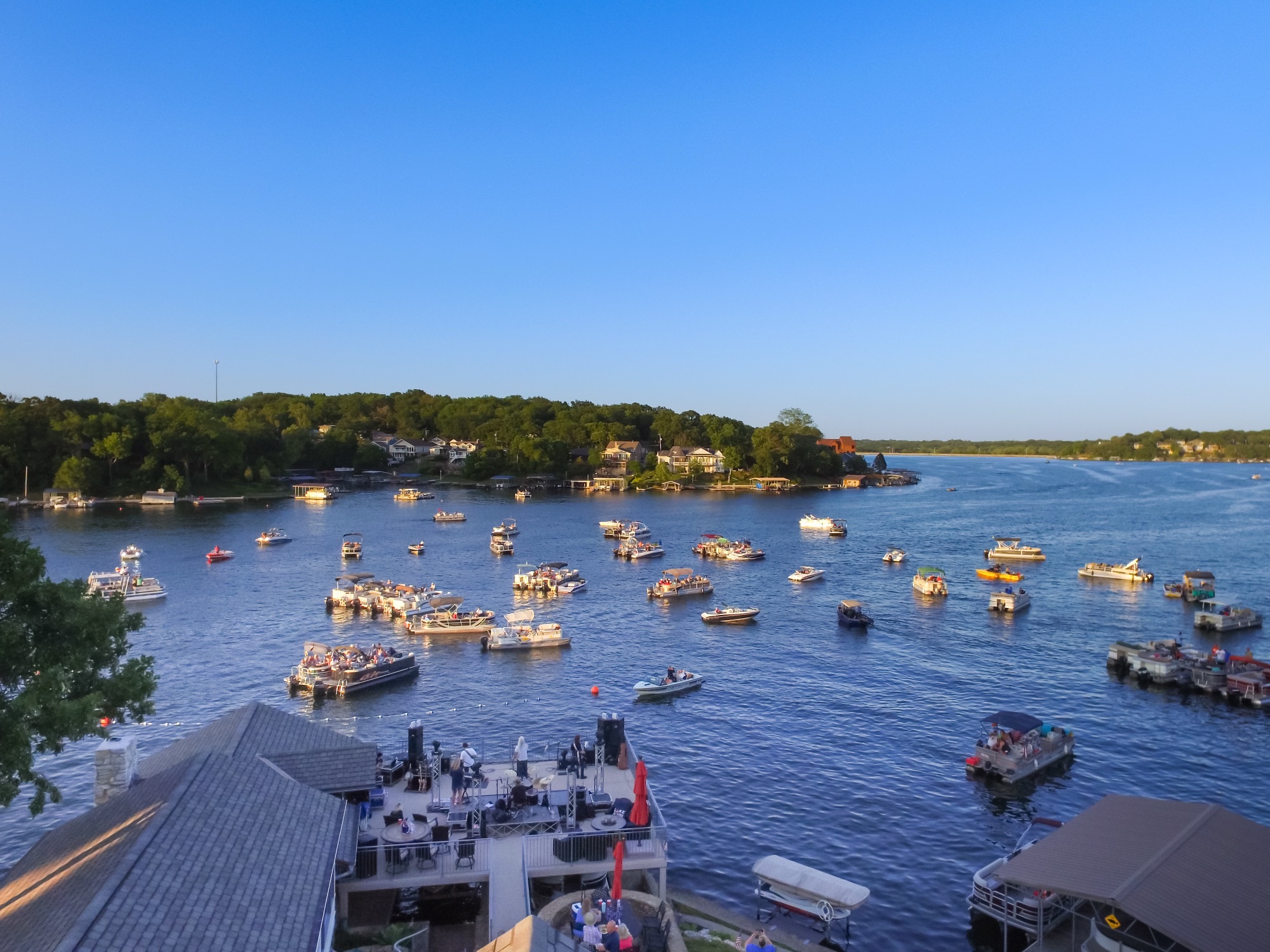 Aerial view of Lake Lotawana concert with dozens of boats in the channel